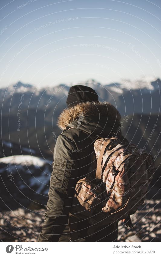 Man in outerwear on snowy mountains Mountain Snow hiker Action motivation Tourist Sunlight Stand Portrait photograph Tourism Weather Cold Extreme