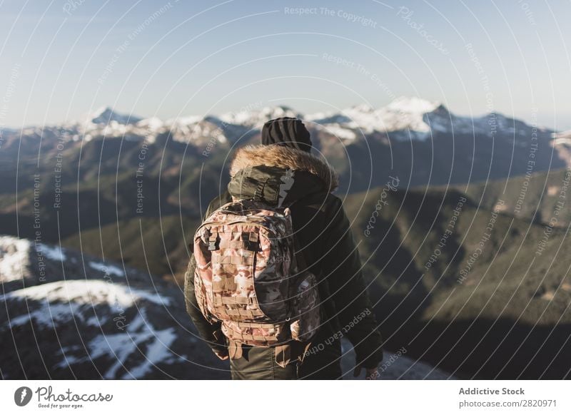 Man in outerwear on snowy mountains Mountain Snow hiker Action motivation Tourist Sunlight Stand Portrait photograph Tourism Weather Cold Extreme