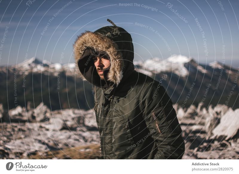 Man in outerwear on snowy mountains Mountain Snow hiker Action motivation Tourist Sunlight Stand Portrait photograph Tourism Weather Cold Extreme