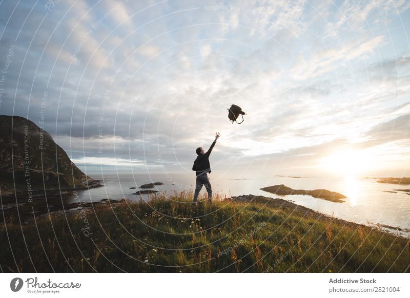 Man throwing backpack on landscape Backpack Freedom Landscape Vacation & Travel Nature Exterior shot Playful Coast Peaceful enjoyment Relaxation Action catching