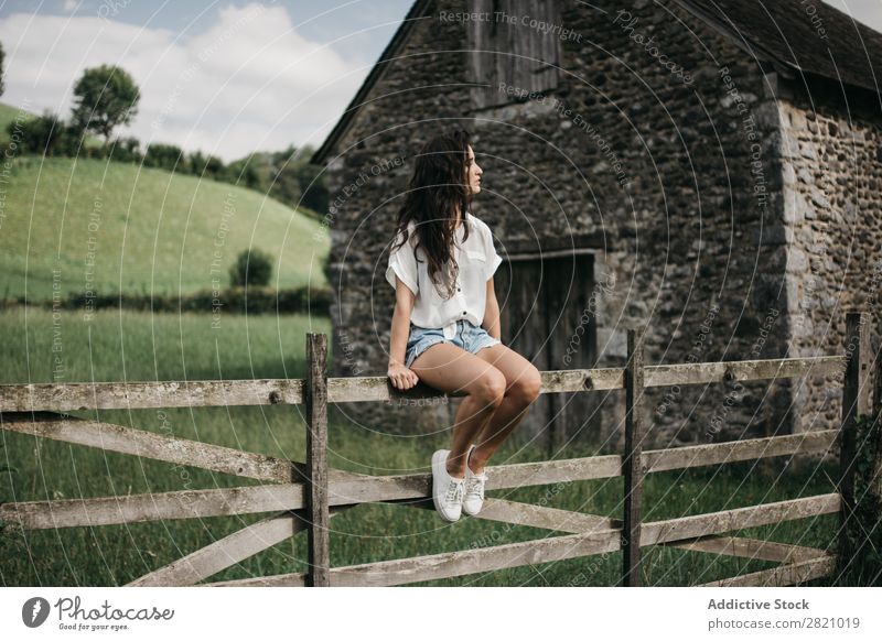 Woman sitting on wooden fence Fence Rural Sit Barn Indicate Wood Nature Landscape Summer Green Beautiful Countries Cute Human being Youth (Young adults) Village