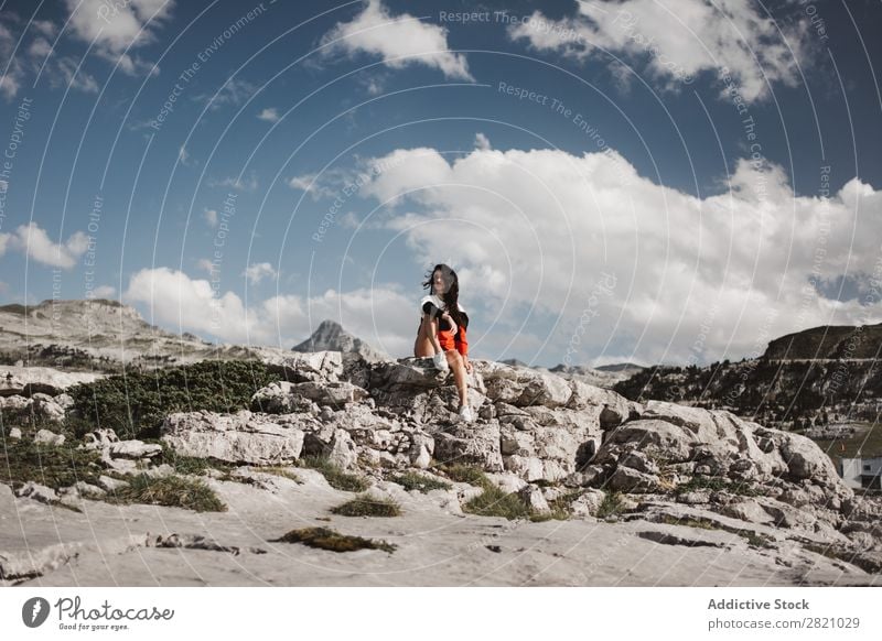 Young woman sitting on rocks Woman Rock Sit Mountain Looking away Vacation & Travel Top Freedom Youth (Young adults) Nature Tourist Peak Adventure Landscape