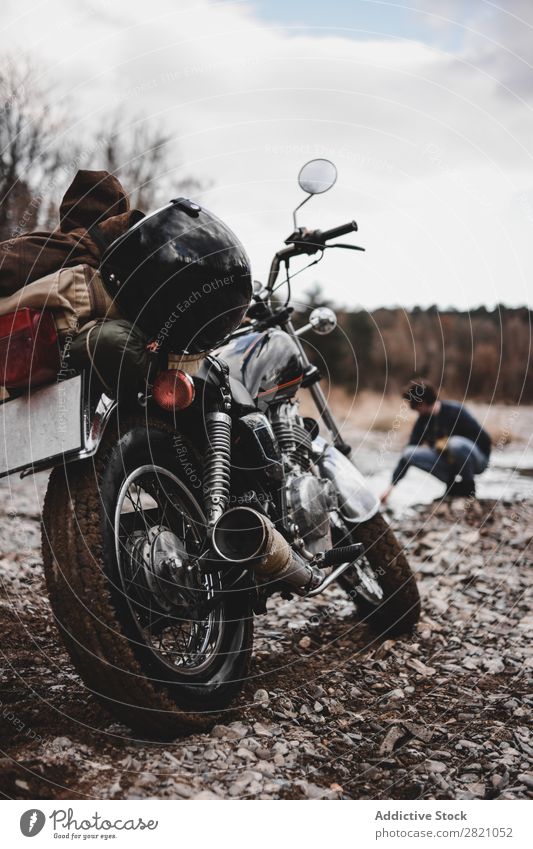 Man sitting near motorcycle Motorcycle Brook Transport Vehicle Freedom Nature Offroad Water Wanderlust Winter Posture traveler Self-confident exploration