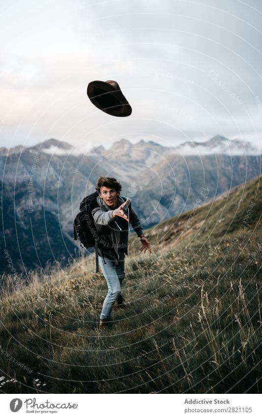 Backpacker posing and throwing hat Man backpacker Adventure Hat Playful having fun in motion Story Expression Expressive Happiness achievement Success Summer