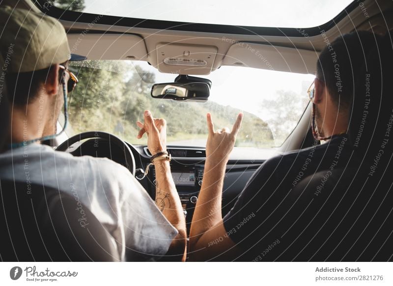 Men gesturing in a car Driving Car Man Friendship Gesture Welcome Trip Happy Summer Street Vacation & Travel Lifestyle Human being Couple Vehicle Joy Smiling