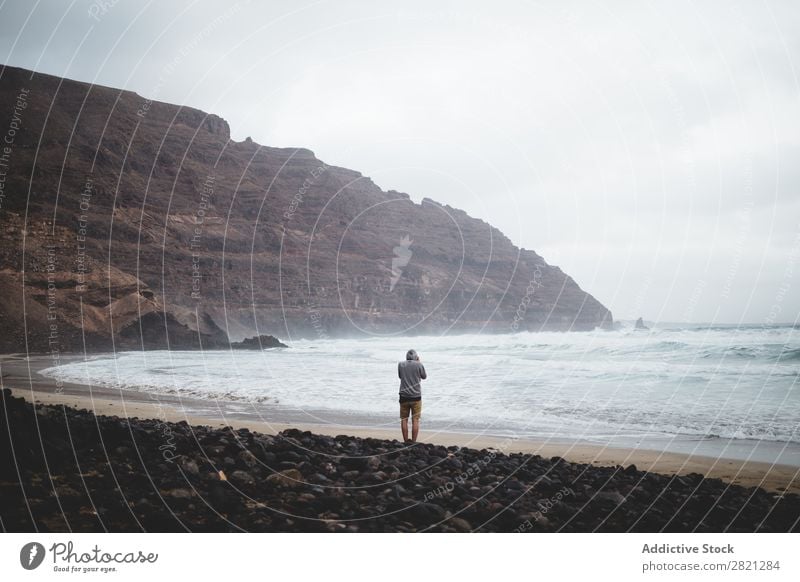 Man posing in a beach Cliff Ocean Vantage point Seagull Waves Landscape Water Coast Vacation & Travel Nature seascape Summer Sky Rock Island Tourism Sunlight