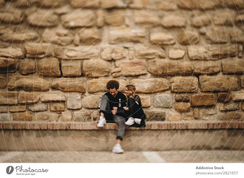 Smiling couple on stone background Couple Portrait photograph Copy Space Background picture Wall (building) Stone Sit Bench Exterior shot Day Hipster Love