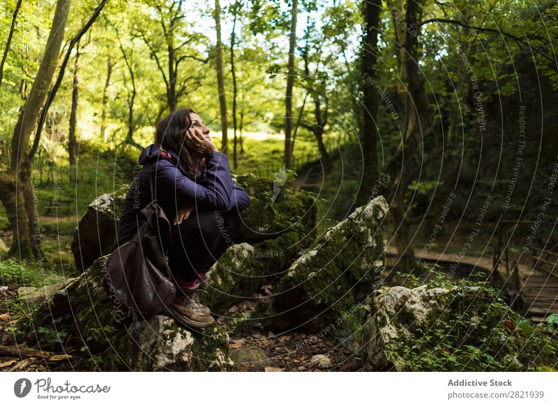 Woman resting in forest Tourist Forest Rest Sit Dream Pensive Stone Considerate Looking away Nature Tourism Vacation & Travel Action Beautiful hiker