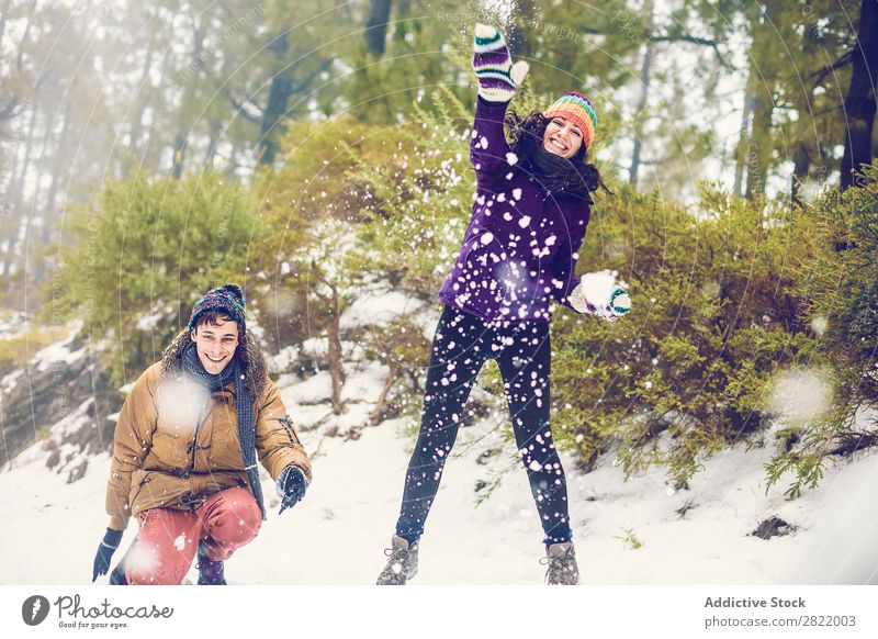 Friends playing snowballs in woods Human being Friendship Snow ball Playing Forest throwing having fun Entertainment Leisure and hobbies Action Movement Winter