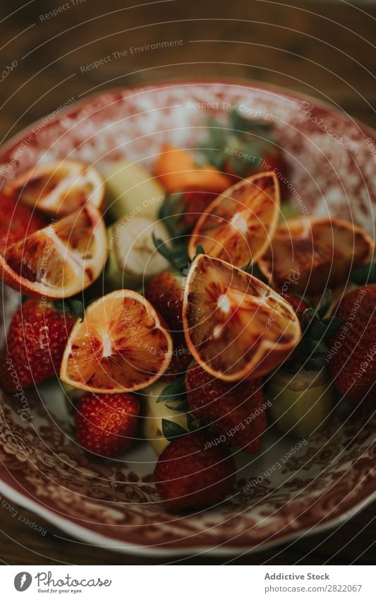 Bowl with different fruits Plate Fruit assortment Orange Red Strawberry Banana pieces Healthy Food Fresh Diet Breakfast Dessert Multicoloured assorted Nutrition