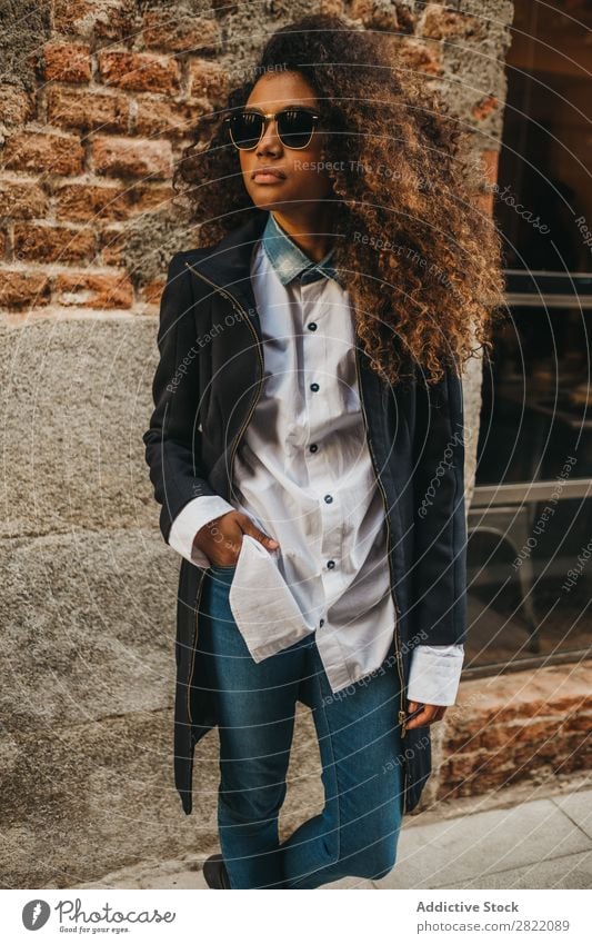 Stylish woman at brick wall Woman pretty Beautiful Ethnic Black Curly African Youth (Young adults) Stand Wall (building) Brick Street Sunglasses Brunette