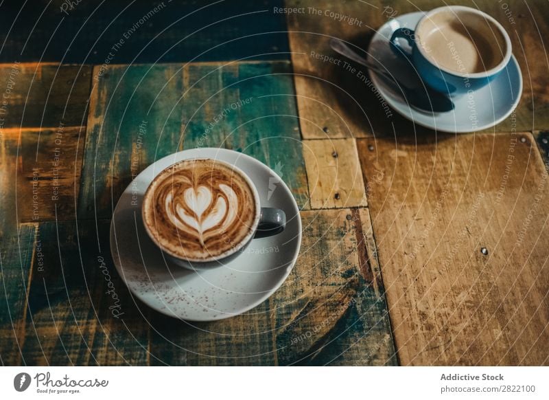 Cup of latte with flower Coffee Table Flower Drinking Hot Brown Foam Café Cappuccino Breakfast Mug ceramic Blue Beverage Food Fresh Art Saucer Wood