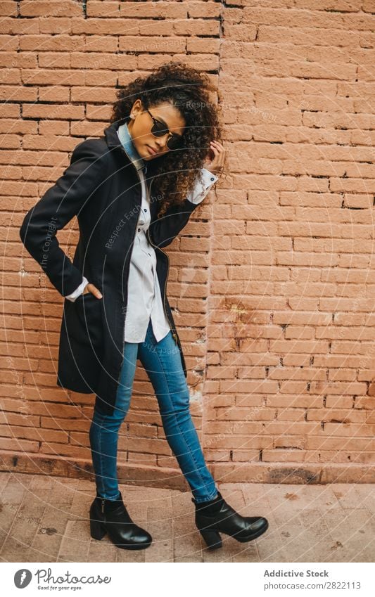 Stylish woman at brick wall Woman pretty Beautiful Ethnic Black Curly African Youth (Young adults) Stand Wall (building) Brick Street Sunglasses Brunette