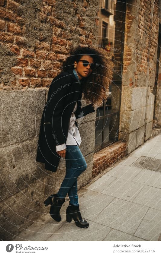 Stylish woman at brick wall Woman pretty Beautiful Ethnic Black Curly African Youth (Young adults) Stand Wall (building) Brick Street Sunglasses Brunette