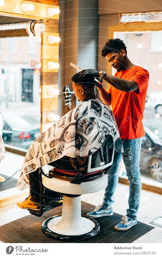 Barber using grooming machine Barber shop Customer hair dress Hair salon Hairdresser Black Man Youth (Young adults) Client Hair Stylist Hair and hairstyles