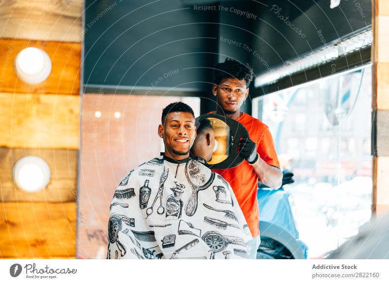 Barber showing haircut to customer Barber shop Customer hair dress Hair Indicate Mirror Reflection salon Hairdresser Black Man Youth (Young adults) Client