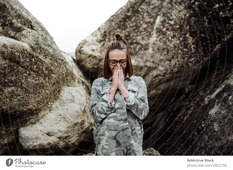 Woman in glasses praying at stones Style Nature Stone Rock Stand eyes closed Person wearing glasses Attractive Beautiful Youth (Young adults) Fashion Hipster