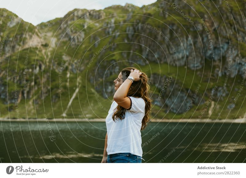 Pretty woman in mountain lake Woman Lake Mountain Smiling Stand Hair Adjust Touch Hill Slagheap Water Youth (Young adults) Summer Vacation & Travel Lifestyle