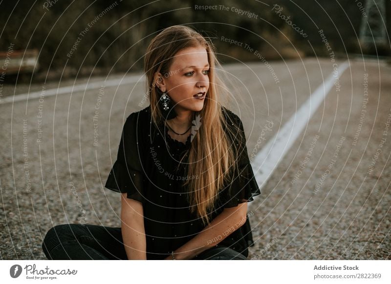 Stylish young woman sitting on roadside Woman Elegant Roadside Nature Posture Self-confident Dream fashionable Gorgeous traveler Provocative Cosmetics roadway