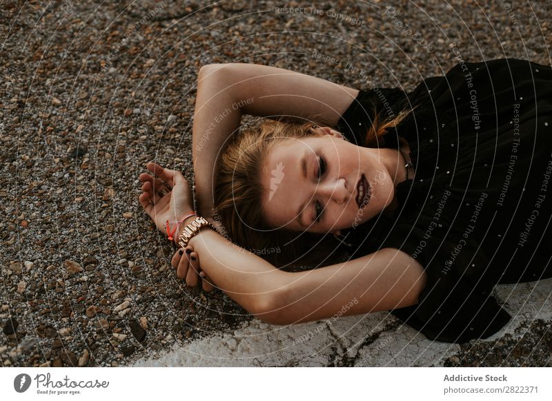 Stylish young woman lying on roadside Woman Elegant Roadside Nature Posture Self-confident Dream fashionable Gorgeous traveler Provocative Cosmetics roadway