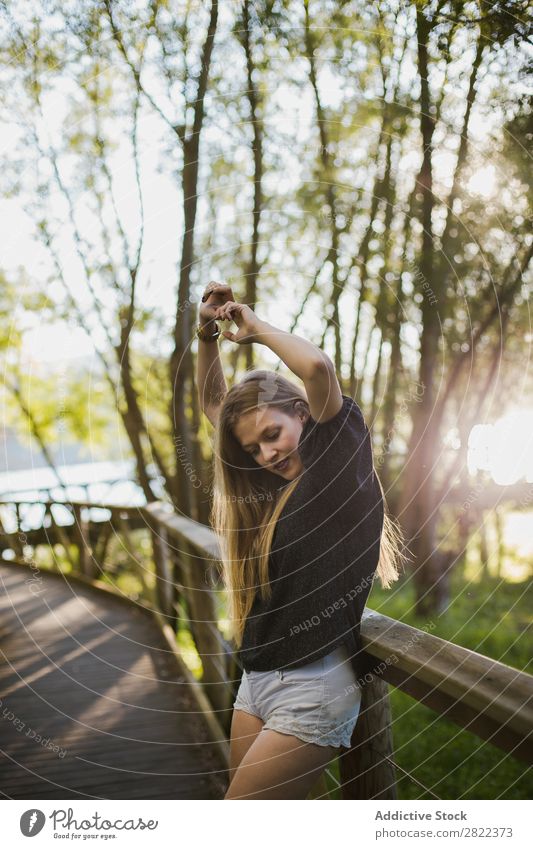 Young woman leaning on bridge railing Woman Bridge Railing Nature Human being pretty Beautiful Leisure and hobbies Summer Portrait photograph Sunbeam Day Tree