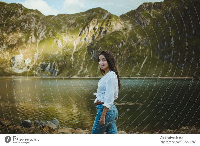 Pretty woman in mountain lake Woman Lake Mountain Smiling Stand Hair Adjust Hill Slagheap Water Youth (Young adults) Summer Vacation & Travel Lifestyle