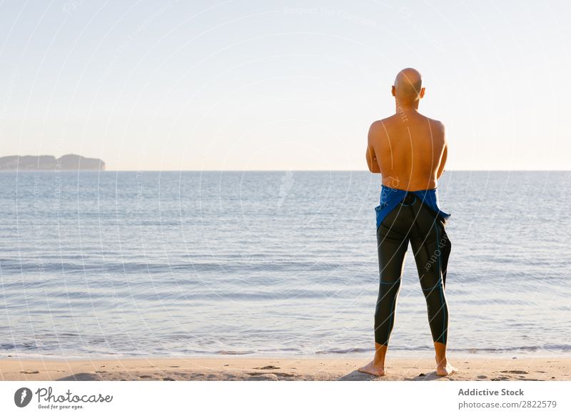 Diver in wet suit standing on beach Man Beach Ocean Vacation & Travel Wetsuit Nature Adventure Sunbathing Leisure and hobbies Beauty Photography Relaxation