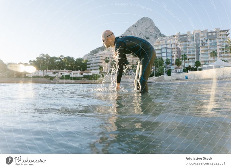 Diver in shallow water preparing to swim Man Wetsuit Ocean Vacation & Travel Relaxation Water Swimming Action Sports Beach Splashing Freedom Adventure