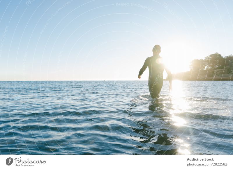 Diver entering the sea Man Wetsuit Ocean Vacation & Travel Relaxation Water Swimming Action Sports Beach Splashing Freedom Adventure Leisure and hobbies Nature