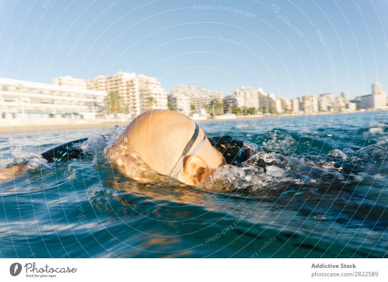 Man in wetsuit swimming in ocean Wetsuit Swimming Ocean Sports Athlete Aquatics Movement Action Water Vacation & Travel Rowing Leisure and hobbies Sunlight