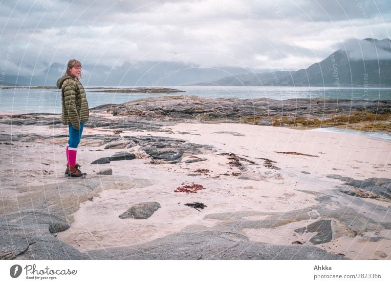 Young woman stands curiously in front of a North Sea coast panorama Vacation & Travel Adventure Youth (Young adults) 1 Human being Landscape Clouds Mountain