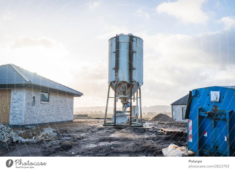 Silo at a construction area with new houses House (Residential Structure) Factory Industry Business Machinery Technology Plant Sky Architecture Transport