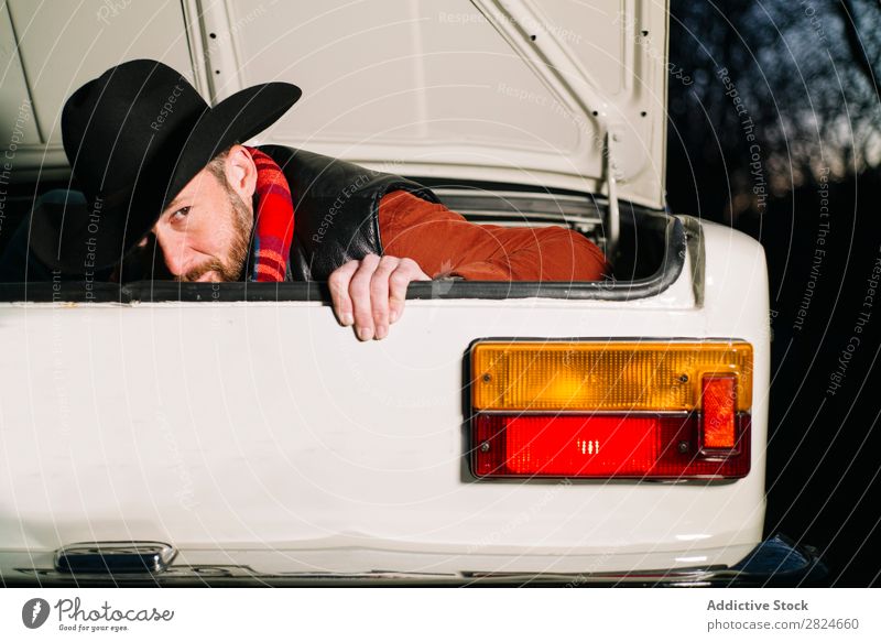 Man in trunk of vintage car Car Vintage Retro White Trunk hiding Hat Evening Vehicle Classic Old Adults Vacation & Travel Human being Transport Drive Elegant