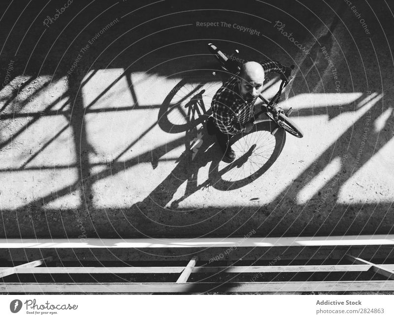 BMX rider performing tricks BMX bike Man Jump Bicycle Sports Trick Youth (Young adults) Lifestyle in motion Action Extreme Black & white photo Rider