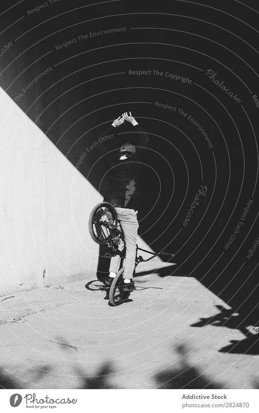 BMX rider standing near wall BMX bike Man Posture Bicycle Sports Youth (Young adults) Lifestyle Action Extreme Black & white photo Rider Motorcycling Practice