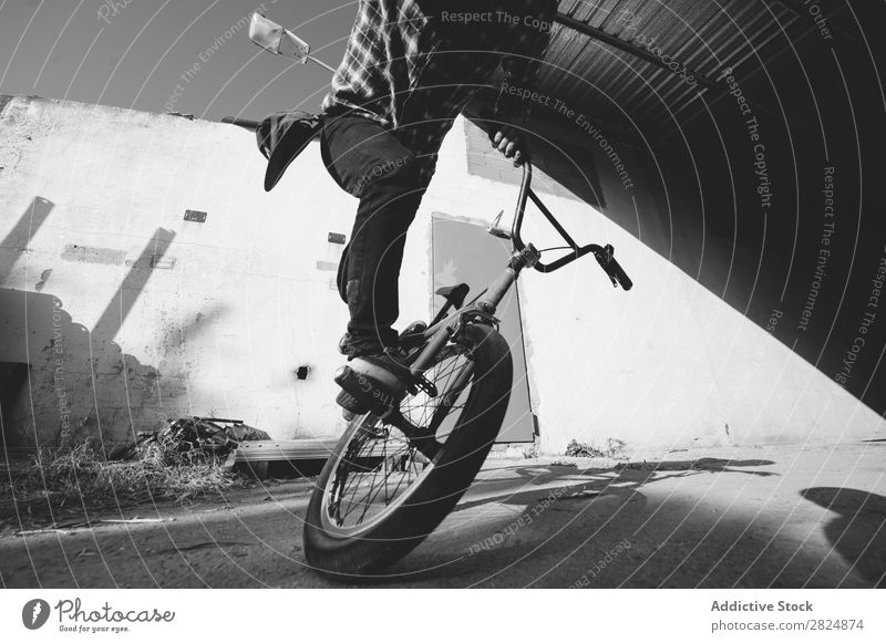 BMX rider performing tricks BMX bike Man Jump Bicycle Sports Trick Youth (Young adults) Lifestyle in motion Action Extreme Black & white photo Rider