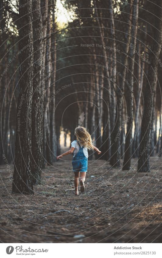 Happy child running in forest Girl Happiness Forest Action Running Freedom grimacing showing tongue Recklessness in motion Leisure and hobbies Nature Innocent