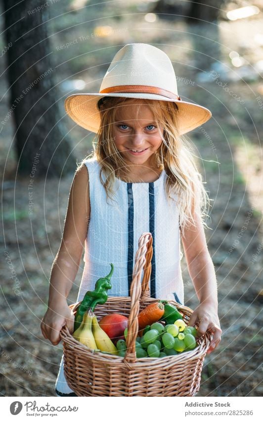 Expressive kid with fruit in basket Girl Basket Posture Summer Harvest Fruit Vegetable Style Excitement Rural Agriculture Landscape Nature Picnic vitamins