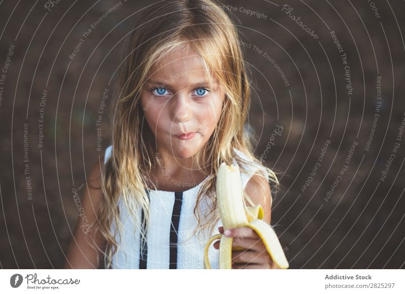 Girl eating banana outside Banana Fruit Garden Posture Portrait photograph Refreshment Eating Fresh Summer Style Rural Healthy Organic Yellow Landscape Nature