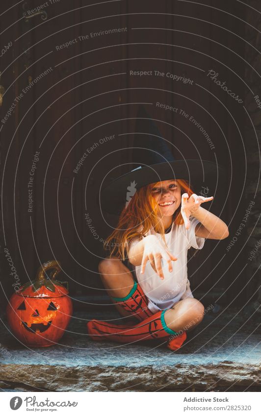 Adorable girl posing playfully Girl Hallowe'en pretend terrify Posture Portrait photograph Cheerful House (Residential Structure) Costume Feasts & Celebrations