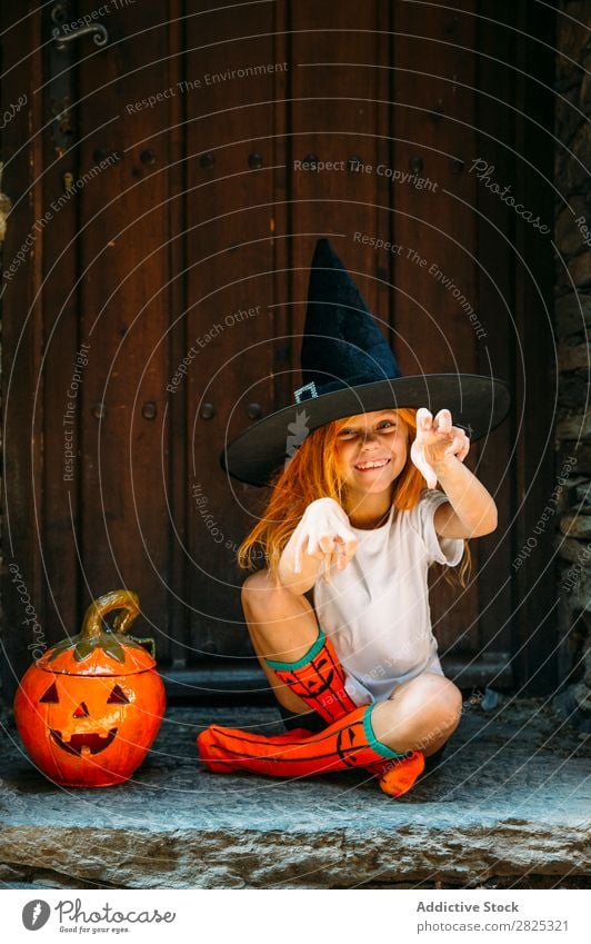 Adorable girl posing playfully Girl Hallowe'en pretend terrify Posture Portrait photograph Cheerful House (Residential Structure) Costume Feasts & Celebrations