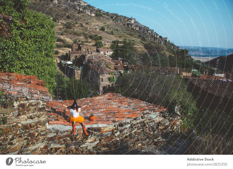 Girl in costume posing on roof Costume Hallowe'en Playful rooftop Feasts & Celebrations Posture Intellect Tradition Expression Seasons Guest Street Infancy