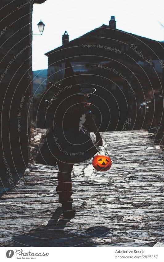 Kid with pumpkin in Halloween Child Hallowe'en Street Costume Witch Tradition Carnival Vacation & Travel Autumn Bucket Culture Girl Holiday season