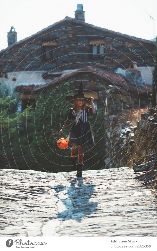 Kid with pumpkin in Halloween Child Hallowe'en Street Costume Witch Tradition Carnival Vacation & Travel Autumn Bucket Culture Girl Holiday season