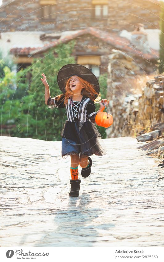 Laughing girl in costume at street Girl Costume Hallowe'en Playful Emotions Feasts & Celebrations Intellect Scream Street Laughter Witch Festival Tradition