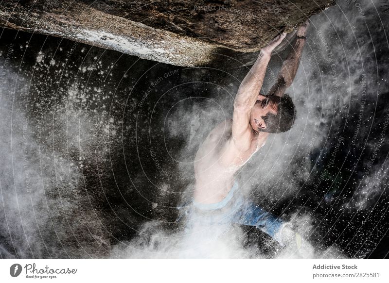 A man climbing on the rock from magnesium, mountain at dusk. Creativity Human being Chalk Climbing Strong Athletic decisions Energy Fingers Stone block Action