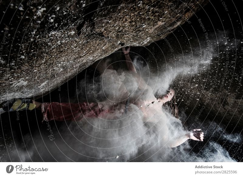 A man climbing on the rock from magnesium, mountain at dusk. Creativity Human being Chalk Climbing Strong Athletic decisions Energy Fingers Stone block Action