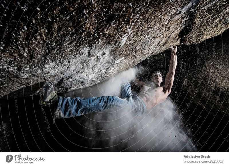 A man climbing on the rock from magnesium, mountain at dusk. Creativity Human being Chalk Climbing Strong Athletic decisions Energy Fingers Stone block Action