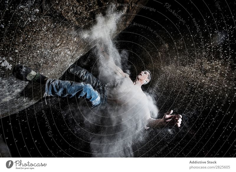 A man climbing on the rock from magnesium, mountain at dusk. Creativity Human being Chalk Climbing Strong Athletic decisions Energy Fingers Stone block Action