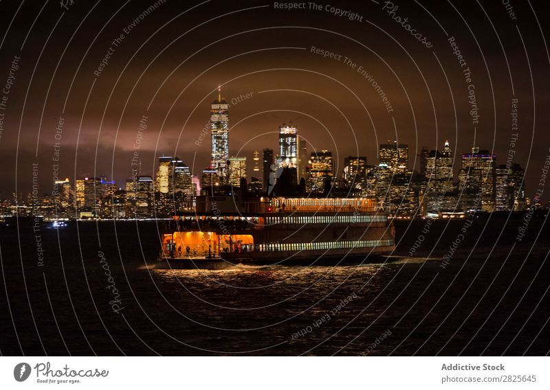 Ferry on the background of city Watercraft Sail Skyline nyc Night Manhattan City Town america Architecture High-rise Building Evening Light Landmark Twilight